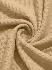 Close-up macro view of breathable tan birdseye mesh fabric texture for tactical polo shirts