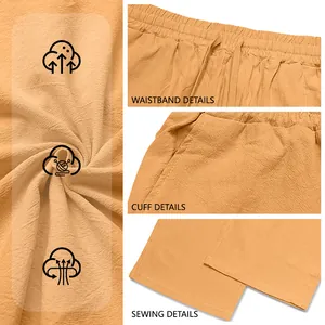 Detail view of orange linen blend drawstring pants showing waistband and texture