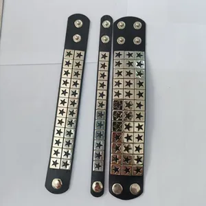 Macro detail of three punk black leather bracelets featuring star metal rivets in different widths