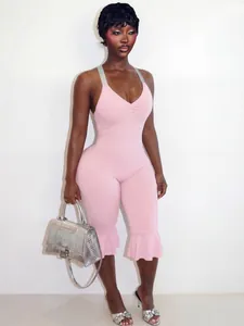 Close-up of pink slim-fit jumpsuit with ruffled hems and V-neckline for summer