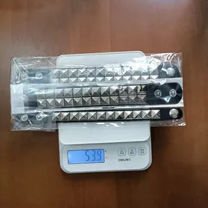 Detail showing three punk studded PU leather bracelets weighing 53.9g on a digital scale