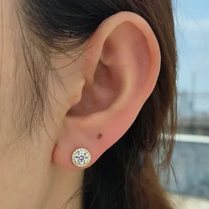 Luxury S925 sterling silver round iced out halo CZ stud earring worn on model ear