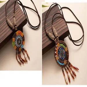 Detailed view of a vintage bohemian long necklace featuring ethnic tassel pendant detail