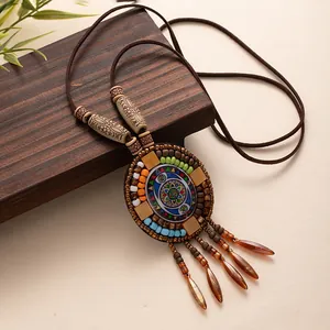 Handmade vintage Bohemian long necklace with colorful beaded pendant and tassels.
