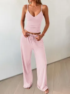 Two-piece pink loungewear set with camisole and wide-leg trousers for a relaxed fit.