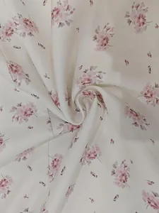 Detail showing soft floral print fabric with elegant pink flowers on cream background