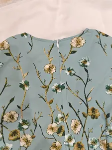 Detailed view of the back invisible zipper on a vintage light blue floral print maxi dress