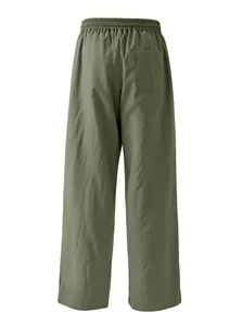 Back view of men's loose olive green linen trousers showing elastic waist and pocket.
