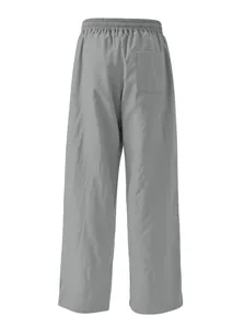 Back view of men's loose casual grey trousers with elastic waist and functional back pocket.