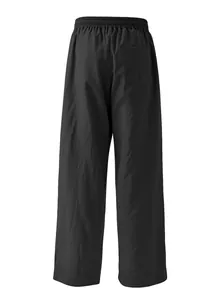 Close-up detail of men's loose black casual trousers with elastic waist and back pocket.