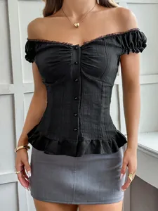 Detail view of a black off-the-shoulder Y2K blouse with ruffled hem and buttons.