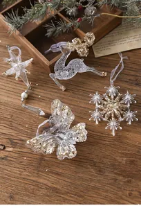 Detailed view of clear acrylic Christmas ornaments with sparkling gold sequins.