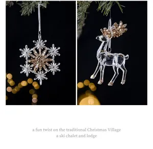 Close-up of crystal acrylic snowflake and reindeer Christmas tree ornaments with gold beads.