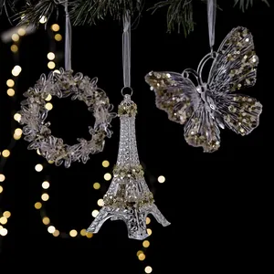 Elegant clear acrylic Christmas hanging ornaments with gold sequins on a dark festive background