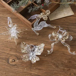 Clear acrylic Christmas ornaments set with gold sequins featuring deer and butterfly