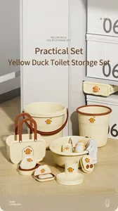 Cartoon yellow duck bathroom storage set with basin, bucket and accessories in a room.