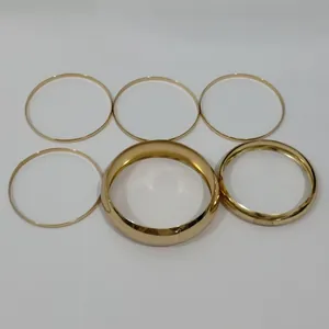 Detailed view of six gold-tone alloy bangle bracelets featuring varying thicknesses.