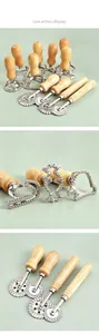 Detail view of zinc alloy cookie cutters and pasta rollers with wooden handles