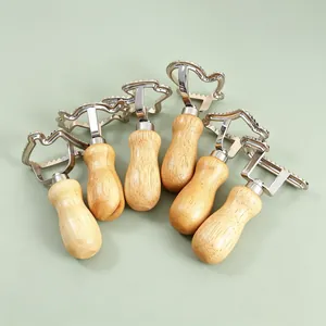 Set of 6 zinc alloy biscuit molds with ergonomic wooden handles for pastry and dumplings.