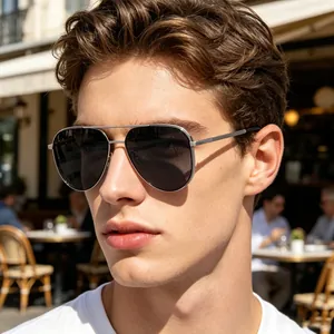 Close-up of a man wearing silver-framed polarized aviator sunglasses outdoors