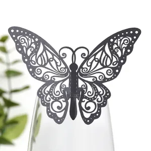 Vue détaillée d'un élégant marque-place papillon noir découpé au laser sur un verre.