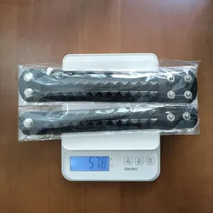 Detailed weight display of two black punk leather bracelets with pyramid studs