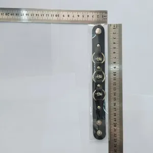 Punk style black leather skull bracelet with rings shown with measurement ruler for scale
