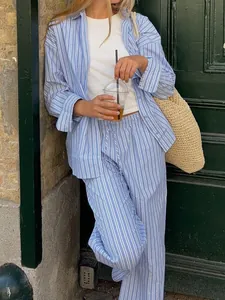 Lifestyle view of women's blue white striped shirt and trousers set for vacation