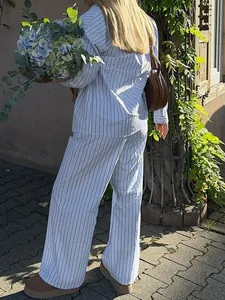 Back view of women's blue and white striped long-sleeve shirt and straight pants outfit
