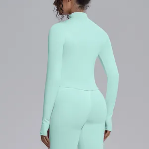 Back view of a mint green mock neck long sleeve slim fit quick dry athletic yoga top