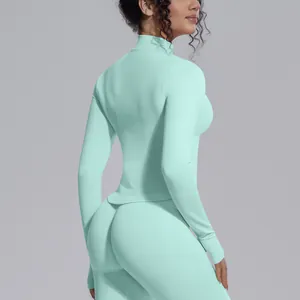 Detail view of a slim fit mint green long sleeve yoga jacket with stand collar
