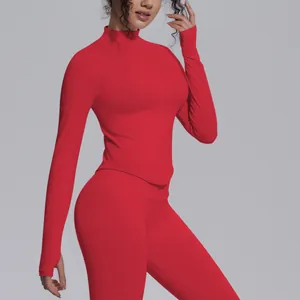 Close-up detail view of red knitted long-sleeve yoga jacket with mock neck and zipper