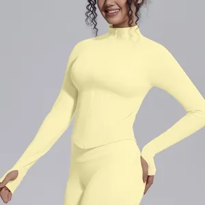 Close-up of pale yellow knitted yoga jacket with thumbholes and zipper detail
