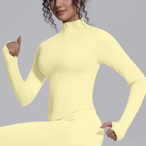 Close-up of mock neck knit yoga jacket featuring slim fit and full zipper in pale yellow