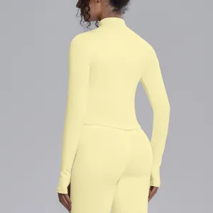 Back view of a slim fit light yellow stand collar long sleeve yoga top and leggings set.