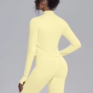 Detailed back view of a pale yellow slim-fit yoga jacket with stand collar and ribbed texture.