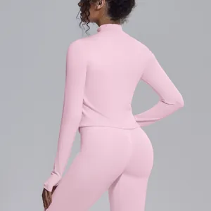 Back view of a pink mock neck yoga jacket and leggings set for professional fitness