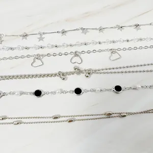 Detailed macro view showing a variety of 6 silver minimalist star and heart charm bracelets