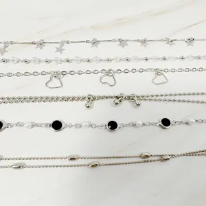 Detailed view of a silver-toned six-piece bracelet set with star and heart charms