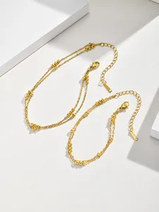 Elegant gold stainless steel double layer bracelet with delicate beads on white background