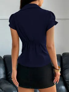 Close-up back view of a navy blue short-sleeved blouse featuring a gathered waist design