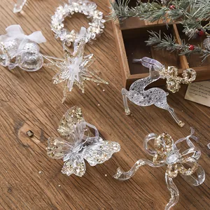 Elegant acrylic Christmas ornaments set with gold sequins on wooden background
