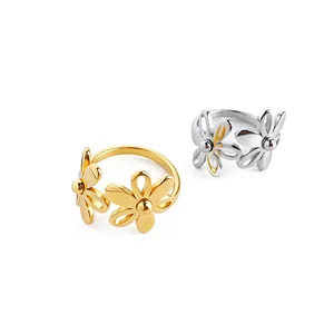 Two minimalist titanium steel open rings with elegant flower design in gold and silver