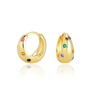 Détail rapproché des créoles en argent S925 dorées avec des zircons colorés vibrants.