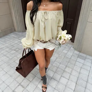 Elegant cream off-shoulder blouse featuring lantern sleeves and a front bow tie