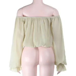 Detail back view of a light green off-shoulder blouse with long lantern sleeves on a mannequin