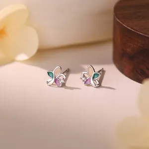 Macro close-up of small colorful butterfly stud earrings in s999 sterling silver