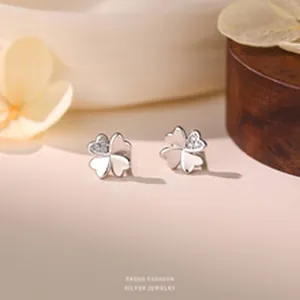 Detailed view of s999 silver four-leaf clover earrings with sparkling zircon inlay