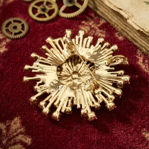 Vue arrière détaillée d'une broche vintage en forme de feu d'artifice dorée avec épingle