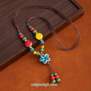 Detailed handmade colorful ceramic bead necklace with flower pendant in ethnic style